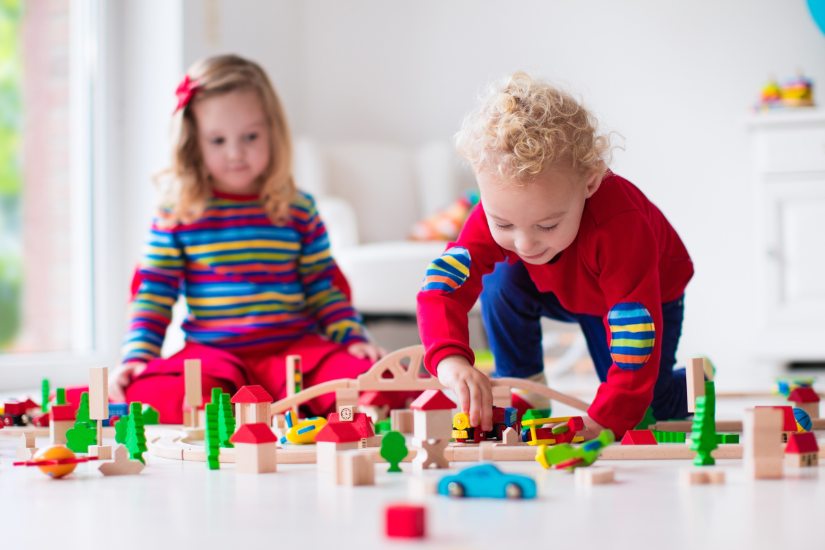 toddlers playing blocks and cars