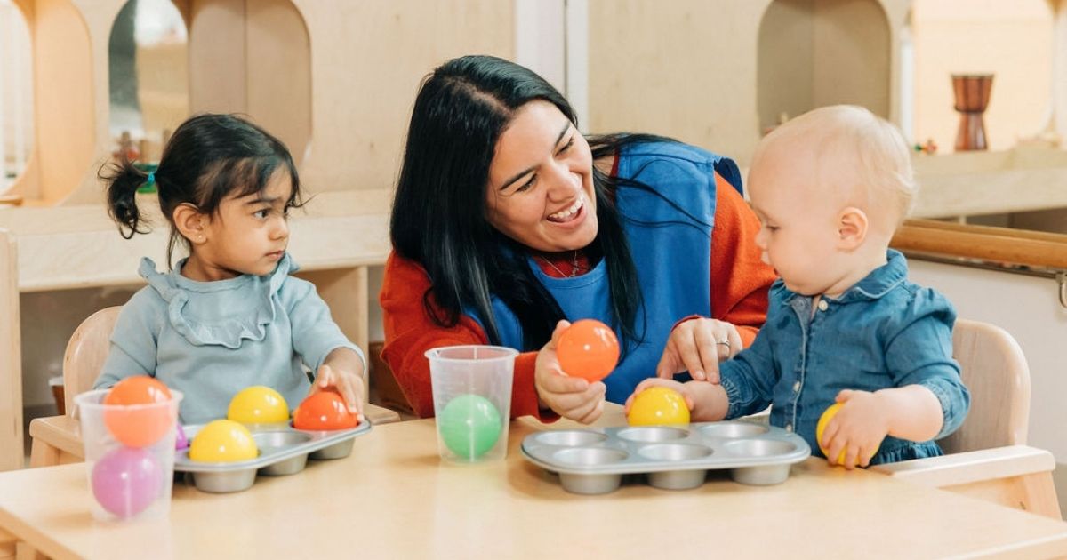 Teacher playing with children at daycare