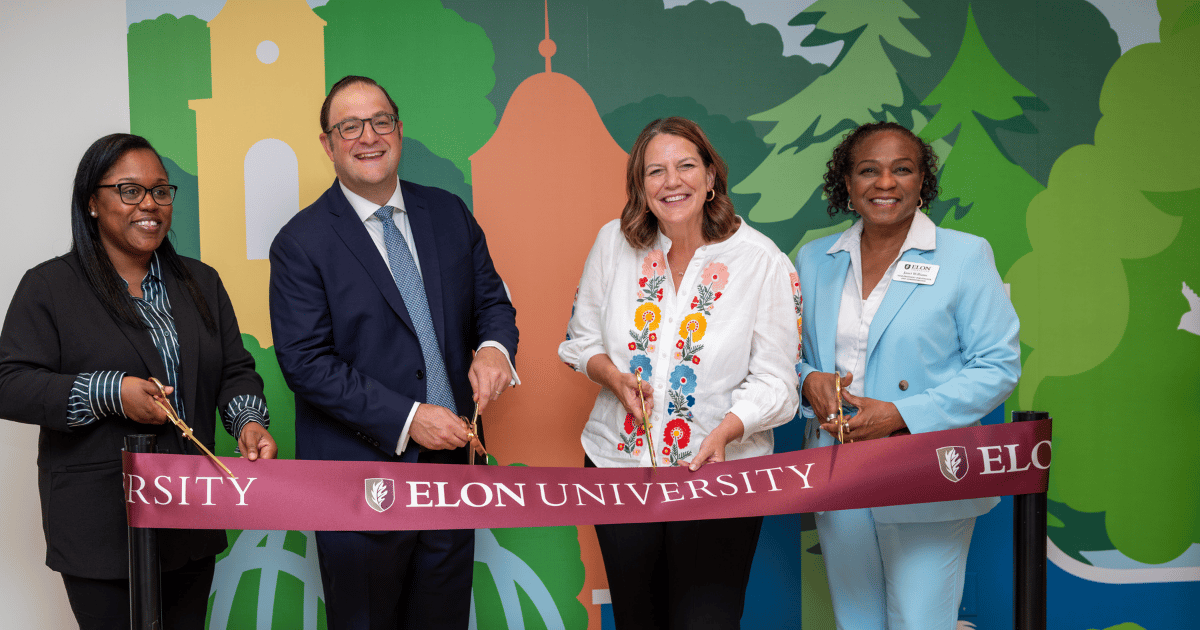 4 people cutting a ribbon at a child care center opening